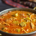 Close up of chicken and Andouille sausage gumbo in a copper bowl. Royalty Free Stock Photo