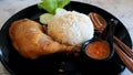 Close up of Chicken braised in soy sauce set on black dish.