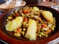 Close up of Chicken Tajine, Moroccan slow-cooked stew served and cooked in earthenware pot.