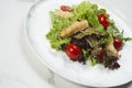 Chicken Tempura Salad served on plate, white marble background