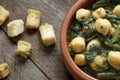 Close up of Chickpea and spinach stew on rustic wooden background. Spanish tapas