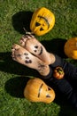 close-up of a child bare feet with a scary grin drawn and the inscription boo in black paint