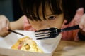 Close up of child girl is eating a delicious pizza.