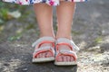 Close up of child girl feet wearing summer sandals shoes Royalty Free Stock Photo