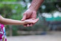 Child girl right hand with asian old man  hand holding on background Royalty Free Stock Photo