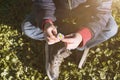 CLOSE UP CHILD HANDS HOLDING A DAISY FLOWER ON SPRING SEASON. HIGH ANGLE VIEW Royalty Free Stock Photo