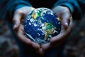 Close up of child hands holding earth globe in dark. Environment conservation concept Royalty Free Stock Photo