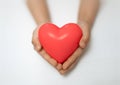 close up of child hands holding red heart shape on a white background. Valentine& x27;s day. Healthcare and donation Royalty Free Stock Photo