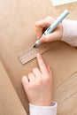 Close-up of child hands in process of sketching with pencil on craft paper. Royalty Free Stock Photo