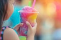 Close up of a child holding a cold slushy crushed ice drink