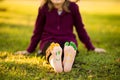 Close up of child human pair of feet painted with smiles outdoor in park