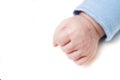 Close up of a child`s fist on white background. Clenched fist - hand of child, baby power. New born baby hand