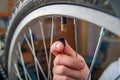 Close-up of child`s hand with cap for bicycle wheel nipple. Pumping tires bike. Royalty Free Stock Photo