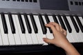 Close-up of a child`s hand playing a synthesizer. Hand of a child playing the piano keyboard Royalty Free Stock Photo