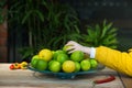 Child's hand reaching to grab a fresh lime from the fruit bowl Royalty Free Stock Photo