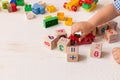 Close up of child`s hands playing with colorful plastic bricks and red motocicle at the table. Toddler having fun Royalty Free Stock Photo