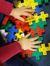 Close up of child`s hands playing with colorful plastic bricks at the table. Royalty Free Stock Photo