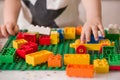 Close up of child`s hands playing with colorful plastic bricks at the table. Royalty Free Stock Photo