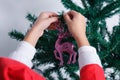 Close-up of child`s hands putting reindeer-shaped Christmas ornament Royalty Free Stock Photo