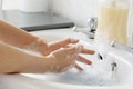 Child& x27;s hand wash his hands over sink in bathroom Royalty Free Stock Photo