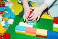 close-up of a child& x27;s hand. A 3 year old boy plays with multi-colored building blocks. children& x27;s toys Royalty Free Stock Photo