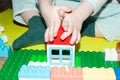 close-up of a child& x27;s hand. A 3 year old boy plays with multi-colored building blocks. children& x27;s toys Royalty Free Stock Photo