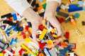 Close up of child& x27;s hands playing with colorful plastic bricks at the table. development of fine motor skills in Royalty Free Stock Photo