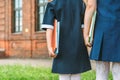 Close-up, Children of an elementary school student holds books in her hands and goes back to school. First day of school. Against Royalty Free Stock Photo