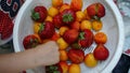 Close-up. A children hands in fist over strawberry in plate. Healthy breakfast