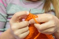 Close-up of children hands knit with needles