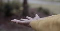 Close up of a children hands playing in the rain.