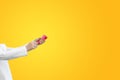 Close-up children hands shooting party popper confetti on empty yellow background with copy space Royalty Free Stock Photo