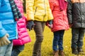 Close up of children holding hands in autumn park Royalty Free Stock Photo