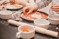 close up. children lay out pieces of salami on the basis of pizza. Royalty Free Stock Photo