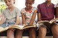 Close Up Of Children Reading On Window Seat Royalty Free Stock Photo