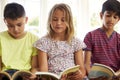 Close Up Of Children Reading On Window Seat Royalty Free Stock Photo