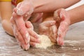 Close-up of children`s and mother`s hands kneading dough. Child prepares burritos or burrito Royalty Free Stock Photo