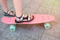 Close-up of childrens feet standing on a skateboard. lifestyle