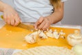 Close-up of childrens hands, cutting knife mushrooms on cutting board Royalty Free Stock Photo