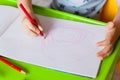 Close-up of childs hands drawing. Boy, drawing a picture for fathers day. Small boy draws at the table