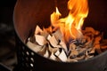 close-up of a chimney starter base filled with burning paper Royalty Free Stock Photo