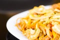 Close up of chinese food, vegetables and noodles with chicken on white dish Royalty Free Stock Photo