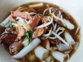 Close up chinese roll noodle soup In a white bowl. Popularly put the pork in boiled water in the sauce and vegetables. Royalty Free Stock Photo