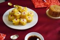 Chinese snacks rice or wheat dough enclosing minced meat and steamed on red color textile Chinese New Year