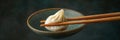 close up chinese steamed dumpling held with chopsticks Royalty Free Stock Photo