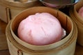 Close up Chinese steamed red pork bun in bamboo basket Royalty Free Stock Photo