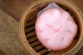 Close up Chinese steamed red pork bun in bamboo basket on wood table background look delicious have copy space Royalty Free Stock Photo