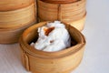 Close up Chinese steamed red pork bun is break can see pork inside in bamboo basket on table Royalty Free Stock Photo