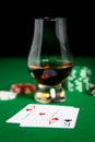 Close up of chips, cards and whisky glass on table