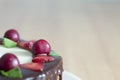 A close up of chocolate cake with cherries, strawberries, chocol
